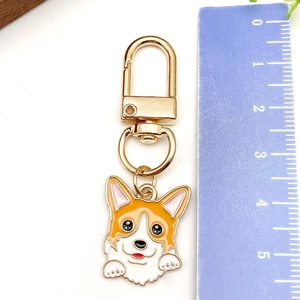 Close-up of cute Corgi enamel keychain with ruler showing 5.2cm total length size