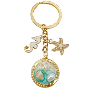 Porte-clés marin doré avec hippocampe en émail, étoile de mer et perle en résine