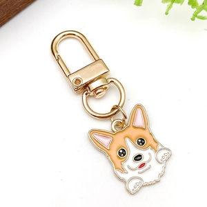 Close-up of cute cartoon Corgi keychain with polished gold lobster clasp and alloy finish