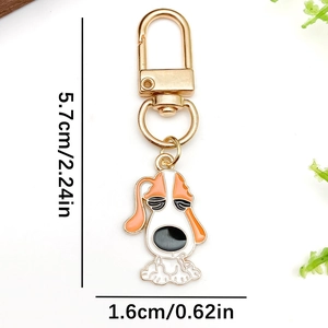 Cartoon dog enamel keychain with orange and white colors on a golden metal hook