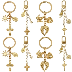 Eight-piece gold alloy religious keychain set featuring crosses, wings, and heart charms