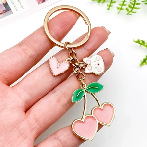 Pink heart cherry keychain with cartoon rabbit and green leaves on gold metal chain