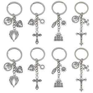 Antique silver wing heart cross alloy keychain set with religious motifs on white background