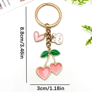 Pink heart cherry keychain with green leaves and cartoon bear charm in gold finish