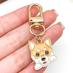 Cute cartoon Corgi keychain made of gold zinc alloy with yellow and white enamel finish