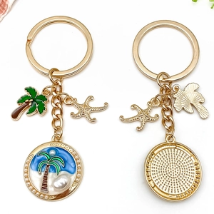 Porte-clés océan tropical avec cocotier doré étoile de mer et pendentif perle