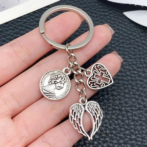 Silver alloy keychain with vintage coin, hollow cross heart, and angel wings pendant charms