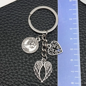 Detailed macro view of vintage alloy heart cross and wing charms with coin pendant
