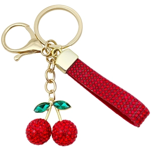 Red resin cherry keychain with sparkling rhinestones and golden hardware on white background