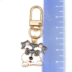 Detailed view of grey Schnauzer enamel keychain with ruler measuring about 6.5 cm
