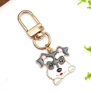 Detail of cute Schnauzer alloy keychain with colorful enamel dripping and golden metal clasp