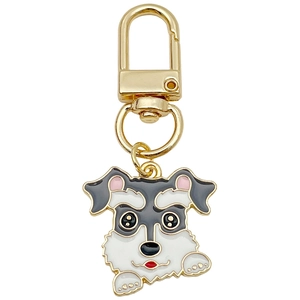 Cute grey and white Schnauzer enamel keychain with gold hardware on white background