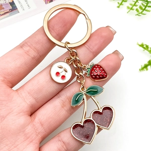 Sweet heart shaped cherry keychain with strawberry pendant in gold alloy finish
