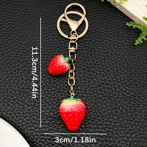 Creative resin strawberry keychain with gold hardware and realistic red fruit charms