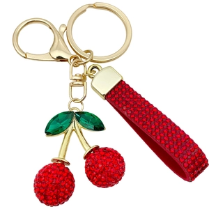 Sparkling red rhinestone cherry keychain with green gem leaf and golden metal ring