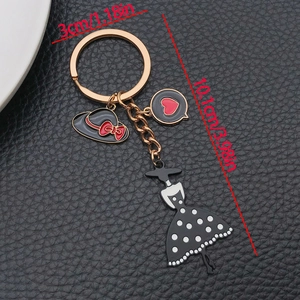 Elegant black enamel dress and hat keychain with gold finish for bags and gifts