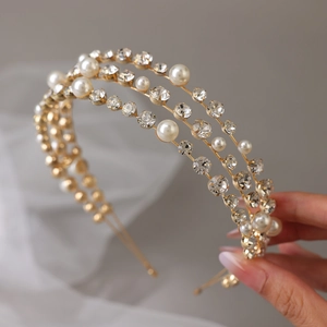 Elegant gold bridal headband with three layers of faux pearls and sparkling crystals