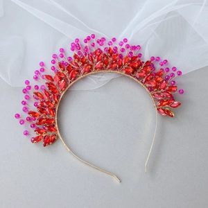 Handmade bridal headband with red crystals and pink beads on a gold frame for weddings