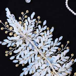 Macro detail of bridal hairband with light blue marquise beads and golden wire weave