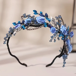 Detail of bridal headband with blue ceramic flowers, rhinestones and silver metal leaves