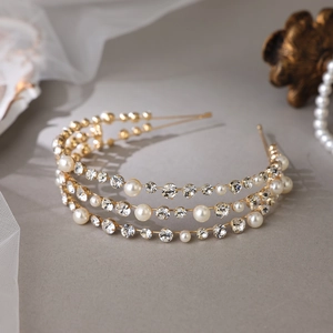 Elegant gold bridal headband featuring triple-layered rows of sparkling rhinestones and pearls