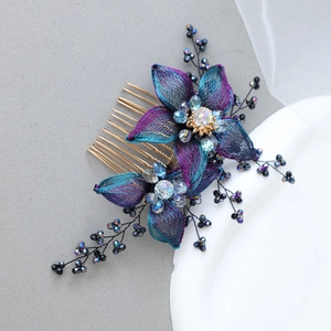 Close-up of handmade floral hair comb with blue-purple mesh petals and crystal beads