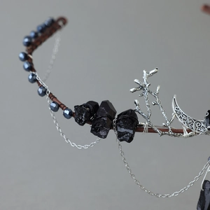 Detail of gothic bridal headband with black natural stones and silver moon tassels