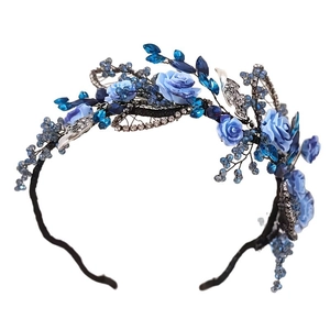 Elegant vintage bridal headband with blue fabric flowers and silver metal leaves