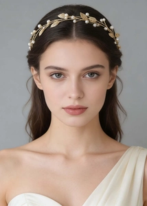 Detailed shot of golden leaf hairband with imitation pearls on a wedding hair accessory