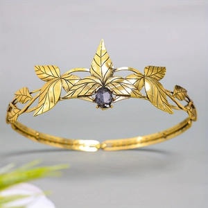 Vintage golden leaf crown with engraved textures and center purple gemstone inlay