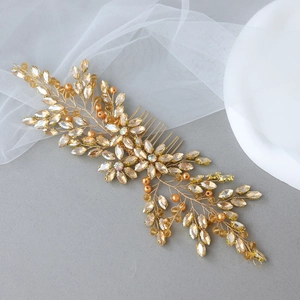 Detail of champagne crystal bridal hair comb with hand-wired gold leaves and pearls