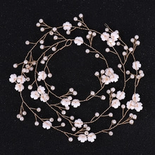 Detail of handcrafted bridal hair accessory with gold wire, white flowers and pearls