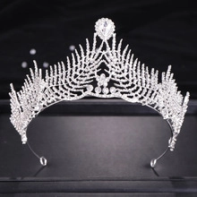Macro shot of silver bridal crown featuring leaf designs and a pear-shaped central stone