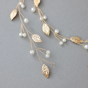 Close-up of handmade gold leaf bridal headband with pearls and intricate vine texture