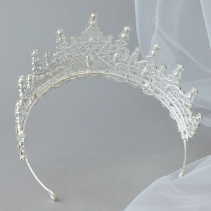 Detail of silver bridal crown with intricate filigree and sparkling rhinestones