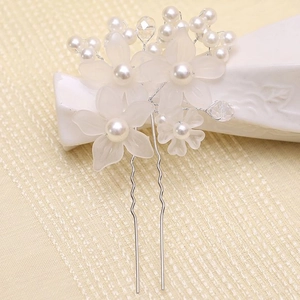 Detailed view of silver hair pin with frosted flowers and white pearl embellishments