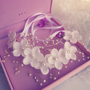 Handmade bridal flower hairpiece with white fabric petals and pearls on gold wire