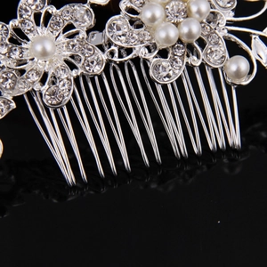 Elegant bridal hair comb with white pearls and sparkling rhinestones on silver metal base