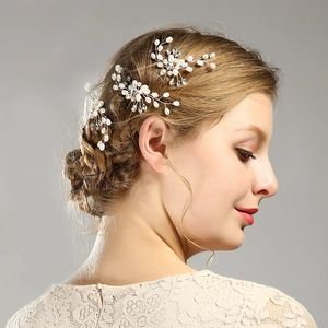Détail d'épingles à cheveux de mariée avec perles blanches et strass sur une tresse
