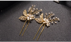 Detailed macro of golden baroque leaf hair pins with white pearls and clear crystals