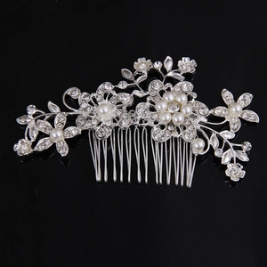 Detailed view of bridal hair comb featuring silver floral rhinestones and white pearls