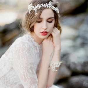 Handmade bridal hairpiece set with white pearls and rhinestones on a lace wedding dress