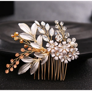 Detailed view of bridal hair comb featuring enamel white flowers and amber beads