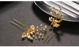 Detailed macro view of baroque golden leaf hair pins with pearls and crystals