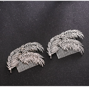 Detail view of silver feather hair combs with sparkling rhinestones for bridal hairstyle