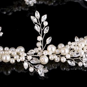 Detail of handmade bridal headband with white pearls and crystals on silver wire
