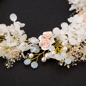 Handmade bridal headband with white flowers, pink roses, and pearls on golden wire