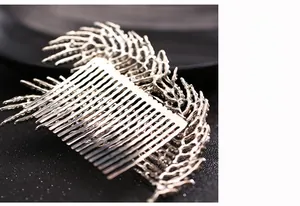 Detailed macro view of silver bridal hair comb with intricate branch-shaped metal texture
