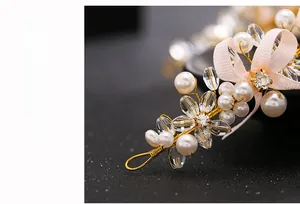 Macro detail of bridal headband with handmade crystal beads, pearls and pink ribbon bow