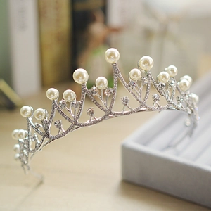 Elegant silver bridal crown featuring pearls and sparkling rhinestones for weddings